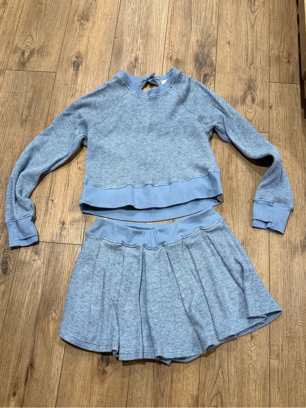 We Are Sundays Womenโs Light Blue Two-Piece Pleated Skort and Sweatshirt Set